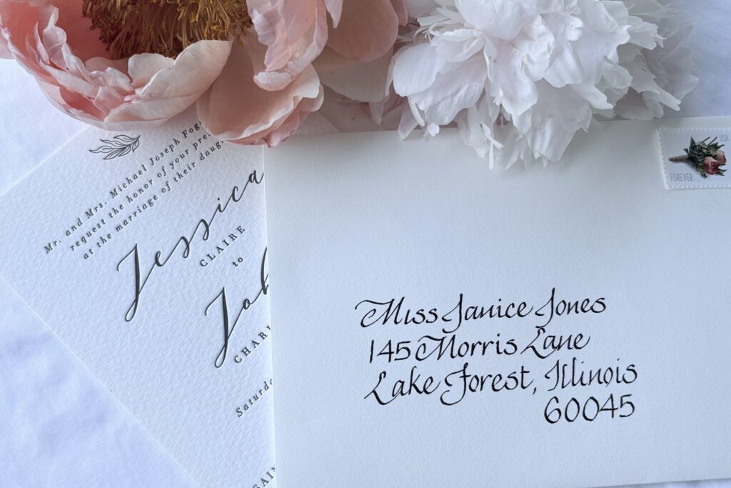 Pink flowers and envelope addressed in Italic calligraphy with a fine nib